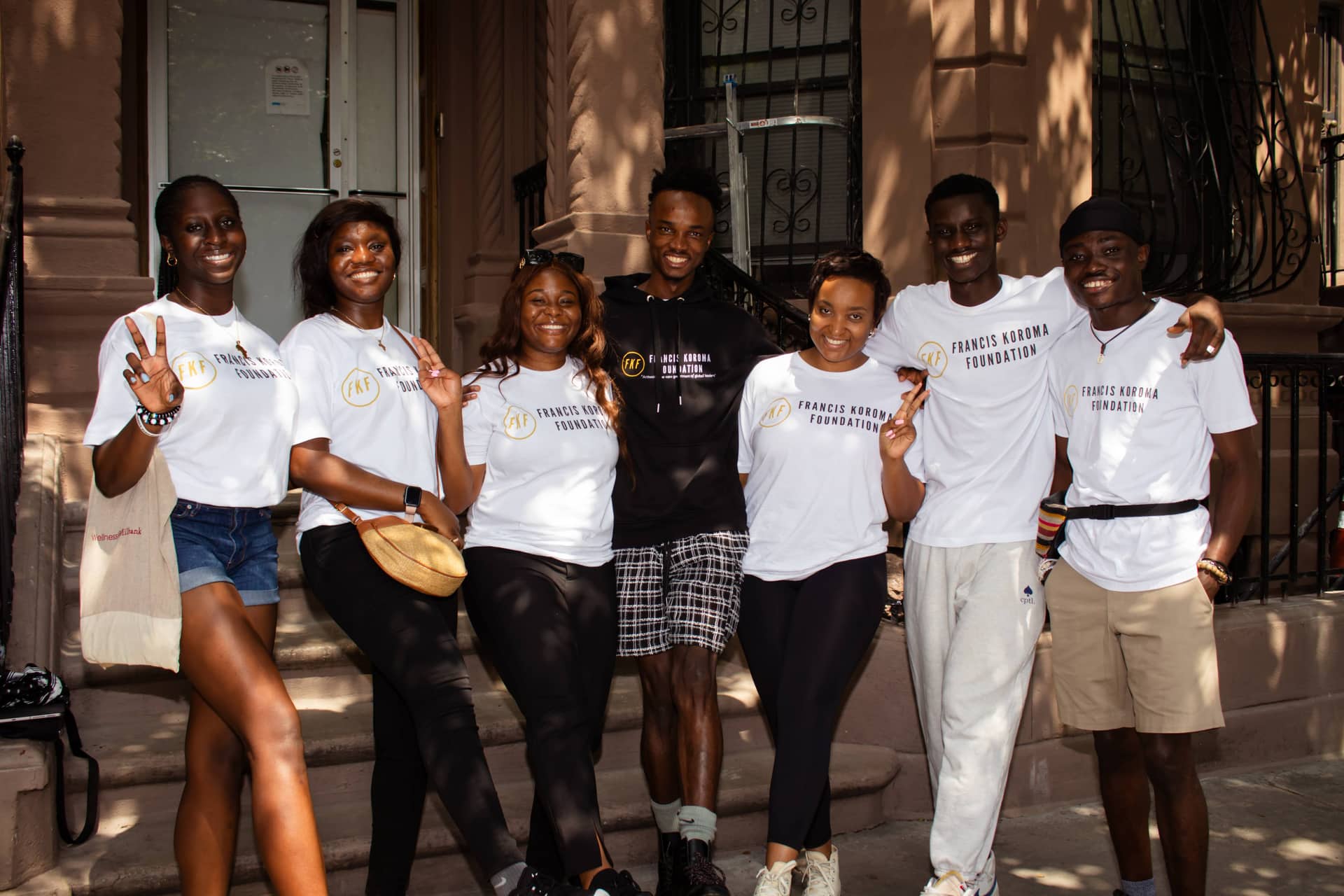 Francis Koroma Foundation volunteers together on brownstone steps